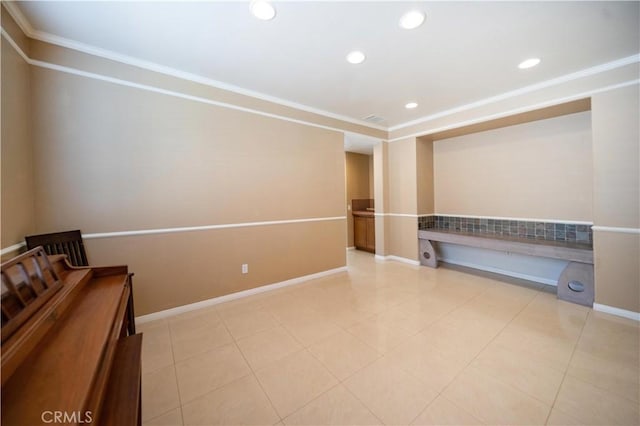 spare room with crown molding, baseboards, and recessed lighting