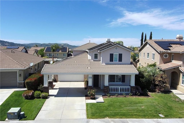 traditional-style home featuring a residential view, driveway, a front lawn, a porch, and a tiled roof