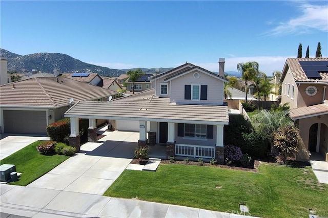 traditional-style house with driveway, an attached garage, a front yard, a porch, and a tile roof