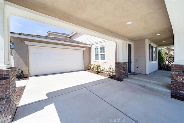 view of front of property featuring a garage, stucco siding, and concrete driveway