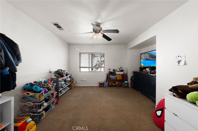 playroom with visible vents, ceiling fan, carpet floors, and baseboards
