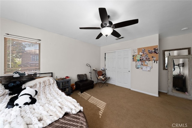 bedroom with baseboards, a closet, carpet flooring, a ceiling fan, and visible vents