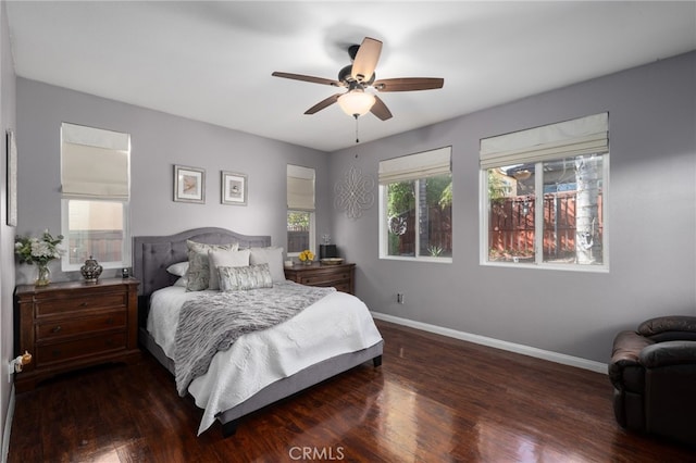 bedroom with ceiling fan, baseboards, and wood finished floors
