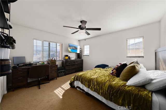bedroom with ceiling fan and light carpet