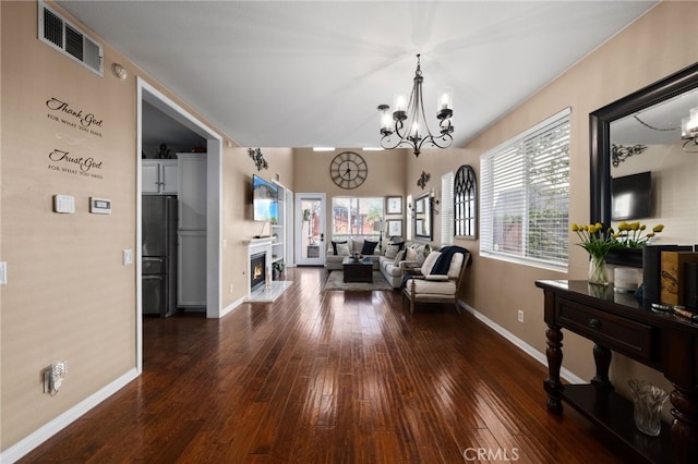 interior space with a chandelier, visible vents, baseboards, and a healthy amount of sunlight