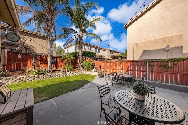 view of patio featuring outdoor dining space and a fenced backyard