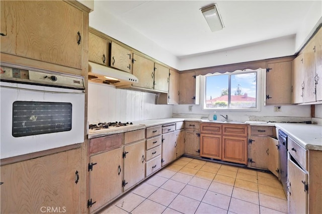 kitchen featuring a sink, light countertops, white appliances, under cabinet range hood, and light tile patterned flooring