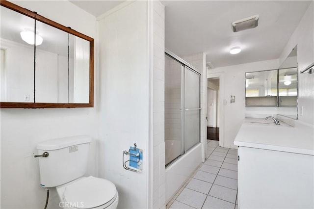 full bathroom with shower / bath combination with glass door, vanity, visible vents, toilet, and tile patterned floors