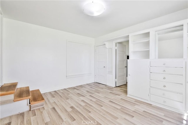 unfurnished bedroom with light wood-style floors