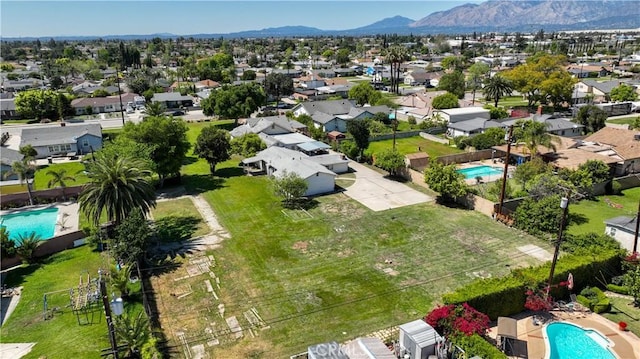 drone / aerial view featuring a residential view and a mountain view