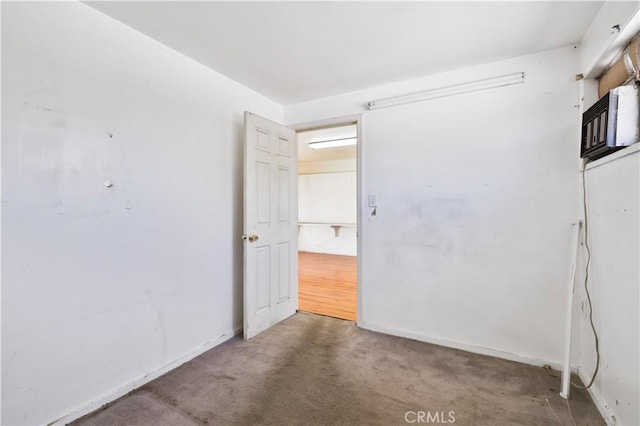 carpeted empty room with baseboards