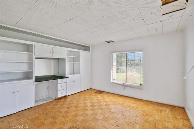 unfurnished bedroom featuring baseboards and visible vents