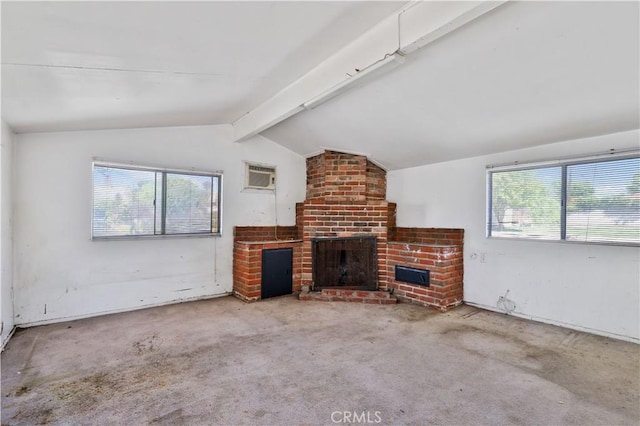 unfurnished living room with an AC wall unit, vaulted ceiling with beams, carpet flooring, and a fireplace