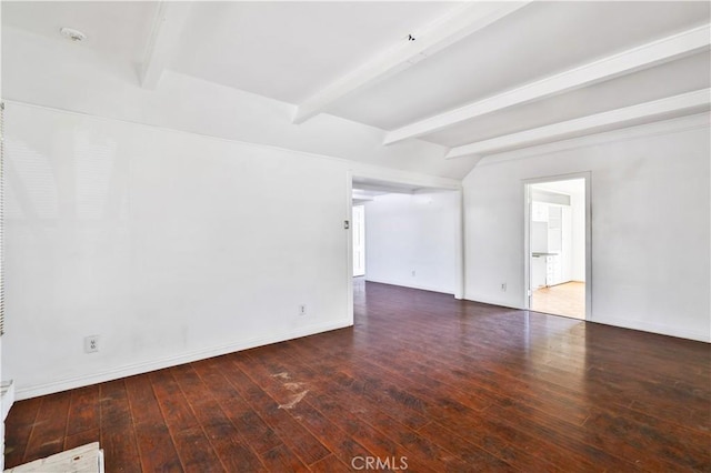 unfurnished room featuring baseboards, hardwood / wood-style flooring, and beamed ceiling