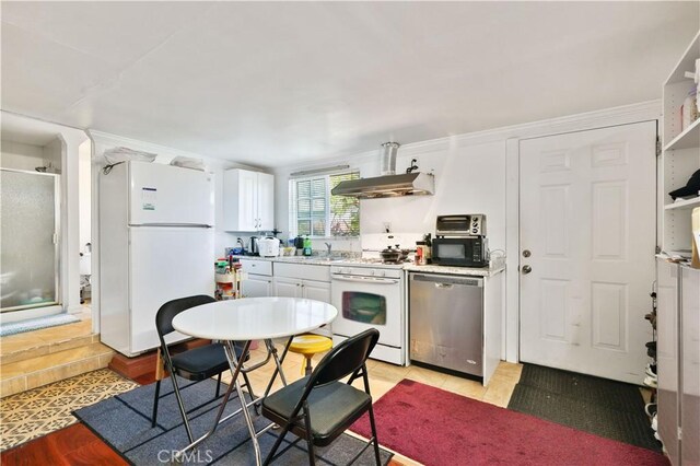 kitchen with white appliances, open shelves, white cabinetry, under cabinet range hood, and a sink