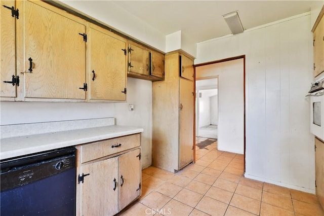 kitchen with white oven, light countertops, black dishwasher, and light tile patterned flooring
