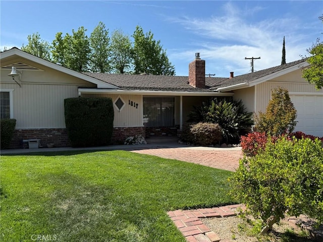 ranch-style house with a front yard, an attached garage, brick siding, and a chimney