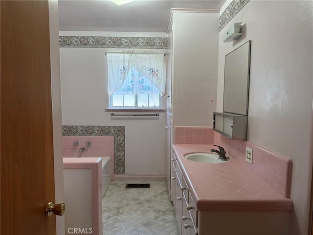 full bath with tile patterned floors, a garden tub, vanity, and visible vents