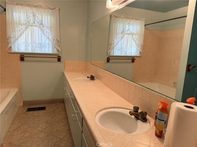 full bath featuring tile patterned floors, double vanity, a sink, and tub / shower combination