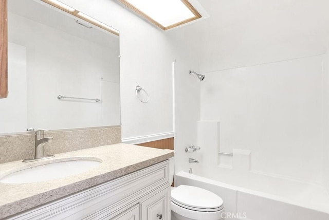 bathroom featuring toilet, vanity, and shower / bathtub combination