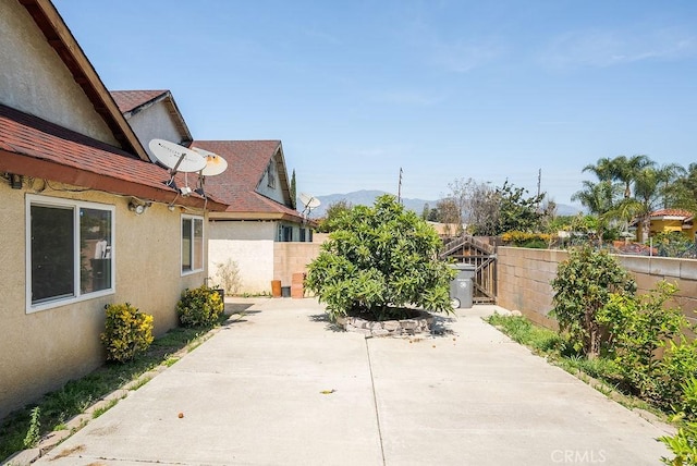 view of patio / terrace with a mountain view and a fenced backyard