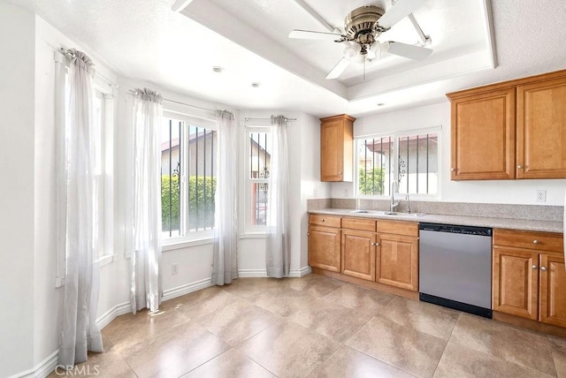 kitchen featuring stainless steel dishwasher, brown cabinets, light countertops, and ceiling fan