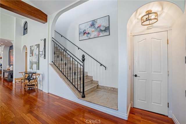 424 Camino De Encanto, Redondo Beach, CA 90277 - foyer entrance featuring stairway, arched walkways, baseboards, and wood finished floors