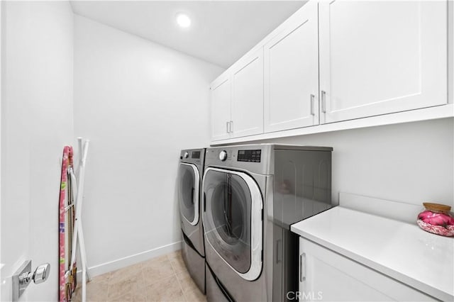 laundry room with recessed lighting, independent washer and dryer, baseboards, and cabinet space