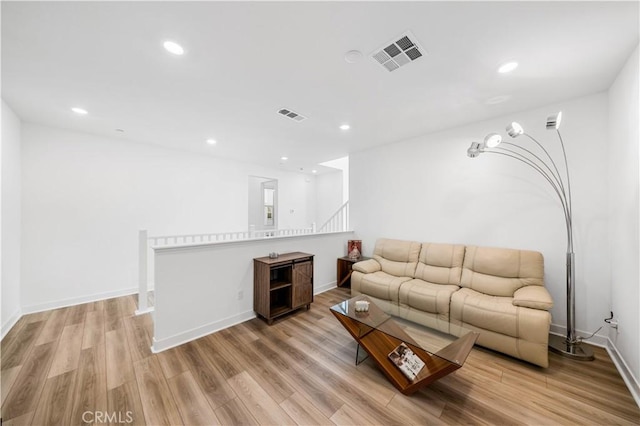 living area with visible vents, recessed lighting, and light wood-style floors