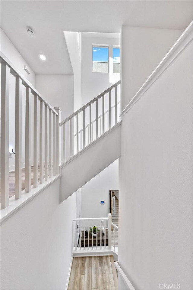 stairway with wood finished floors