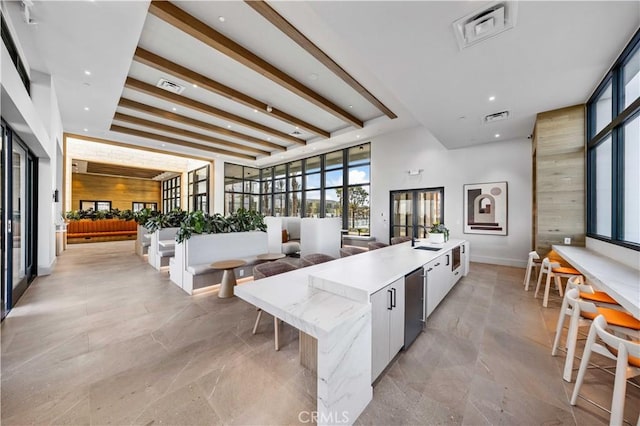 kitchen with visible vents, modern cabinets, and a spacious island