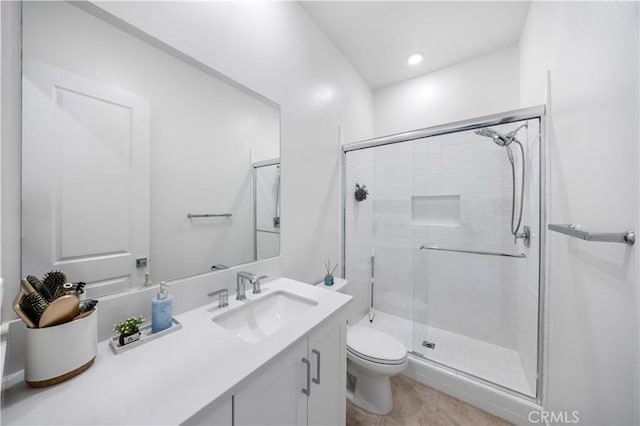 bathroom with toilet, vanity, a shower stall, and recessed lighting