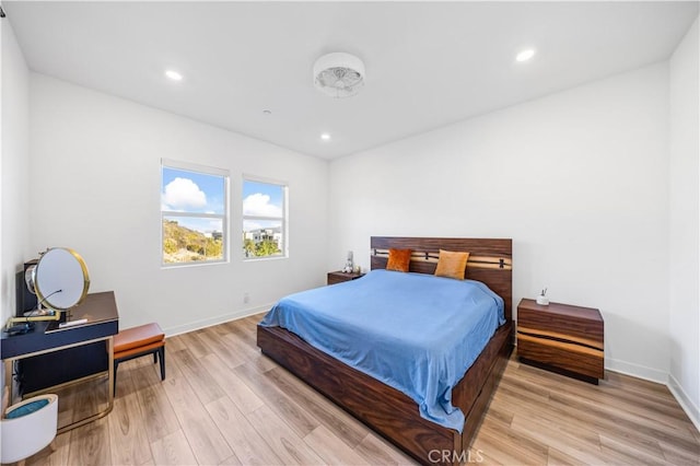 bedroom with recessed lighting, light wood-type flooring, and baseboards