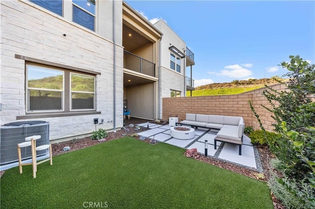 view of yard featuring central air condition unit, a patio, an outdoor living space with a fire pit, and fence