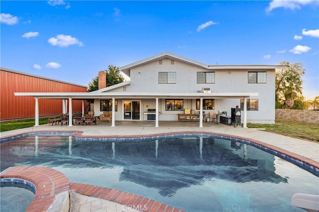 41018 40th St W, Palmdale, CA 93551 - rear view of house with stucco siding, a patio area, outdoor dining space, and an outdoor living space