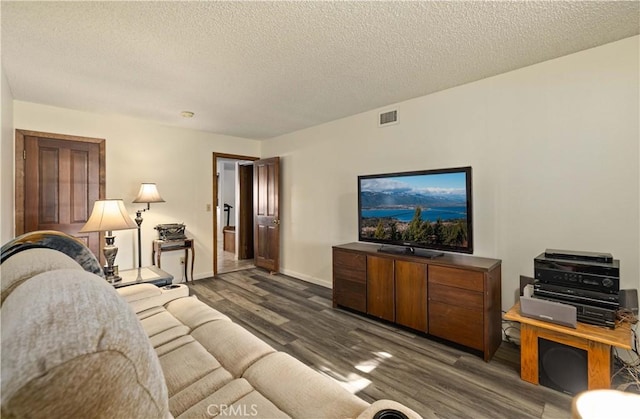 41018 40th St W, Palmdale, CA 93551 - living room with dark wood-style floors, a textured ceiling, and baseboards