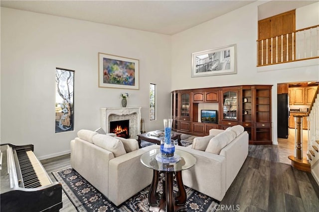 41018 40th St W, Palmdale, CA 93551 - living area with a fireplace, dark wood-type flooring, and baseboards