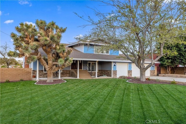 41018 40th St W, Palmdale, CA 93551 - view of front of house featuring driveway, stone siding, covered porch, and a garage