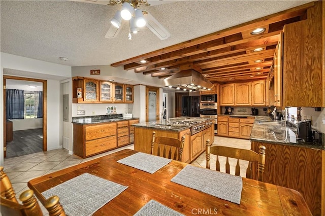 41018 40th St W, Palmdale, CA 93551 - kitchen featuring stainless steel appliances, ceiling fan, a kitchen island with sink, glass insert cabinets, and a sink