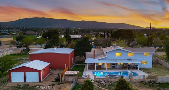 41018 40th St W, Palmdale, CA 93551 - view of swimming pool featuring a fenced backyard, a mountain view, a pole building, and an outbuilding