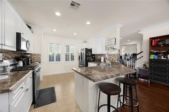 5384 Palestrina Way, Fontana, CA 92336 - kitchen featuring ornamental molding, visible vents, appliances with stainless steel finishes, a sink, and dark countertops