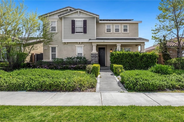 5384 Palestrina Way, Fontana, CA 92336 - craftsman house featuring stucco siding, stone siding, and roof mounted solar panels