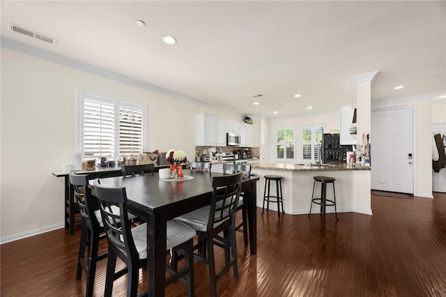 5384 Palestrina Way, Fontana, CA 92336 - dining space featuring crown molding, visible vents, recessed lighting, baseboards, and dark wood-style floors