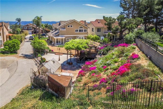 view of property's community featuring fence and a residential view