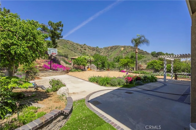exterior space with a mountain view, a patio, and a pergola