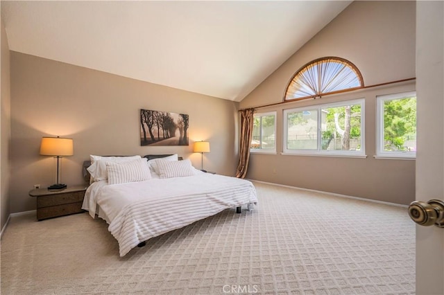 bedroom with baseboards, high vaulted ceiling, and light colored carpet