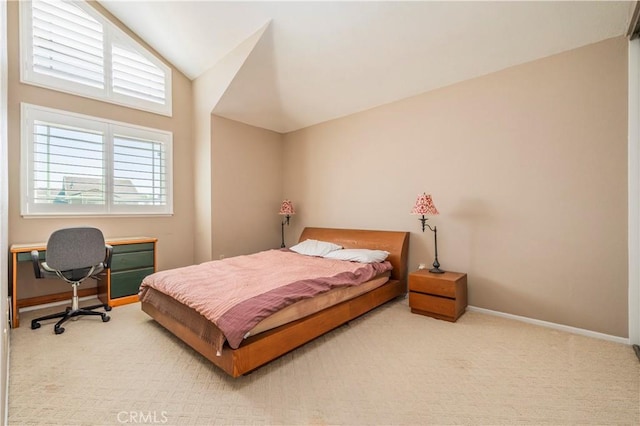 carpeted bedroom featuring baseboards and vaulted ceiling