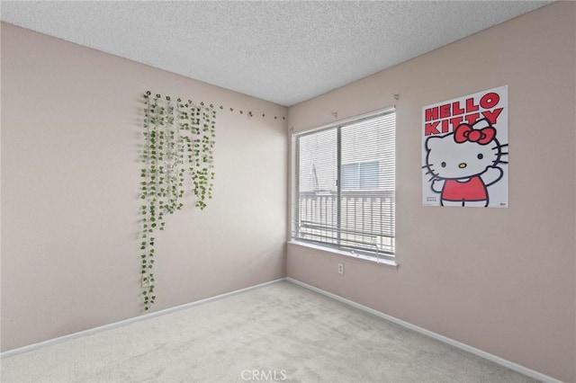 unfurnished room with baseboards, a textured ceiling, and carpet floors