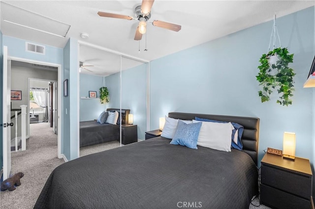 bedroom with ceiling fan, visible vents, carpet, and a closet