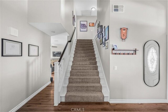 27884 Beacon St, Castaic, CA 91384 - staircase with baseboards, a ceiling fan, wood finished floors, and visible vents